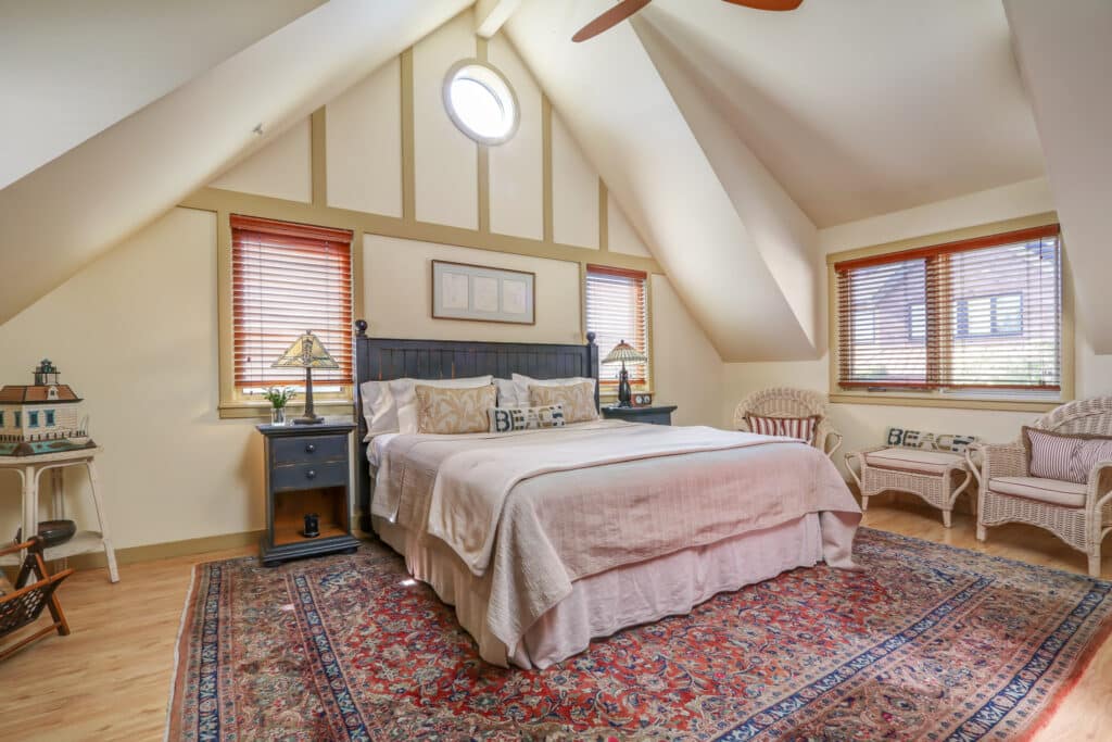 The king-sized bed and valuted ceilings of the Rockaway Beach guest room at Eagle Harbor Inn on Bainbridge Island WA. Close to all the best things to do in Poulsbo, WA.